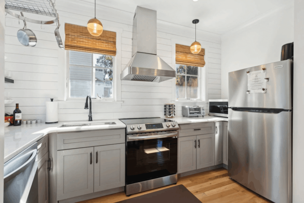 A fully equipped modern kitchen in a 257 Rutledge Charleston SC, featuring clean countertops, high-end appliances, and bright lighting, perfect for extended stays.