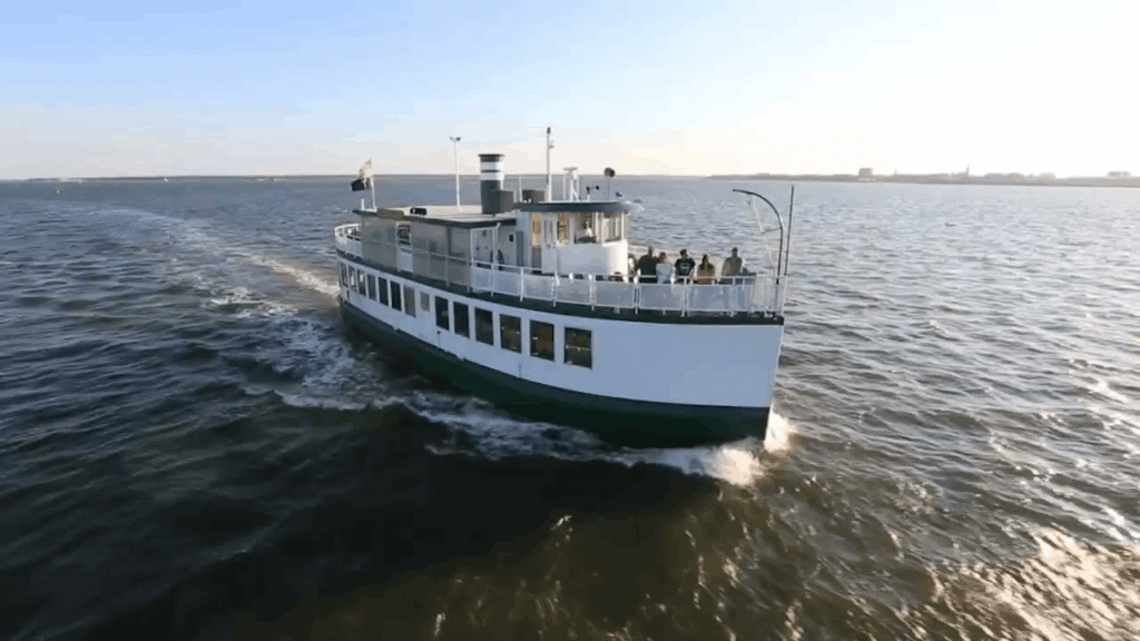 The Carolina Belle tour boat cruising through the water during a Charleston Harbor Tour in South Carolina.