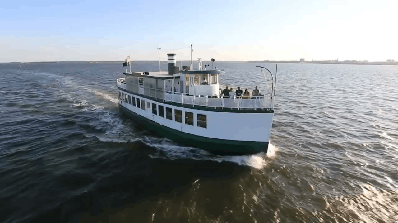 The Carolina Belle tour boat cruising through the water during a Charleston Harbor Tour in South Carolina.