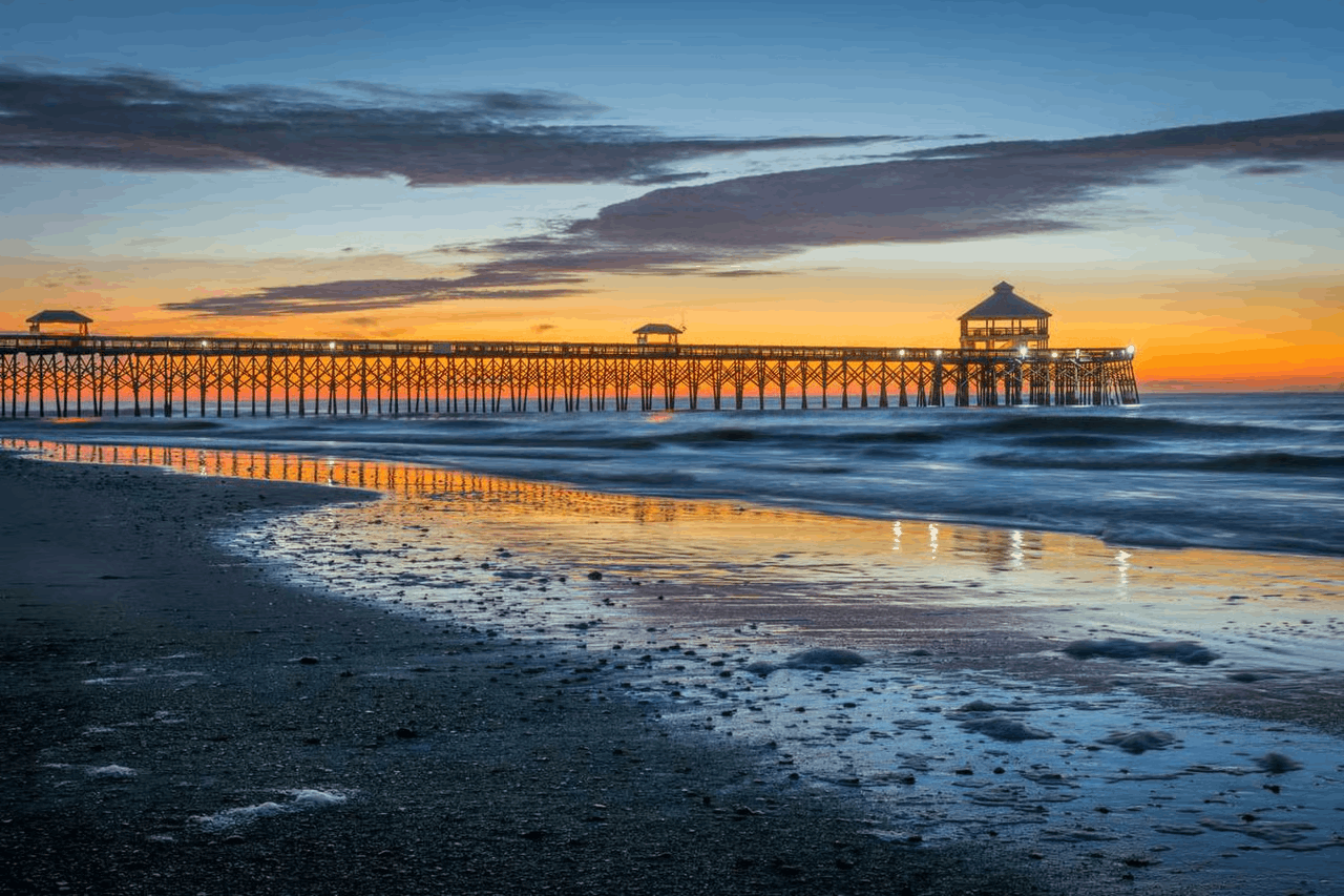 Folly Beach Fishing Pier near Charleston, South Carolina during a scenic sunset, perfect for a beach day trip.