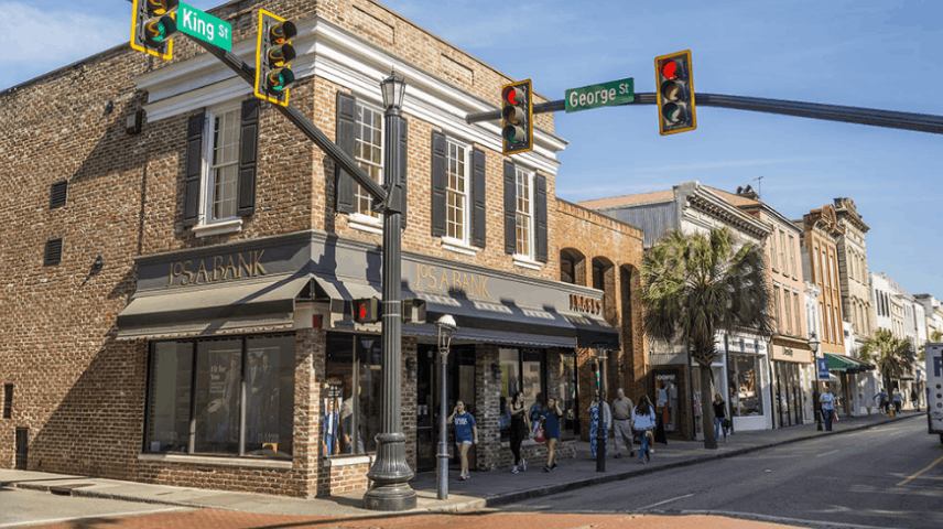 The intersection of King Street and George Street in historic downtown Charleston, South Carolina, featuring a Jos. A. Bank store.